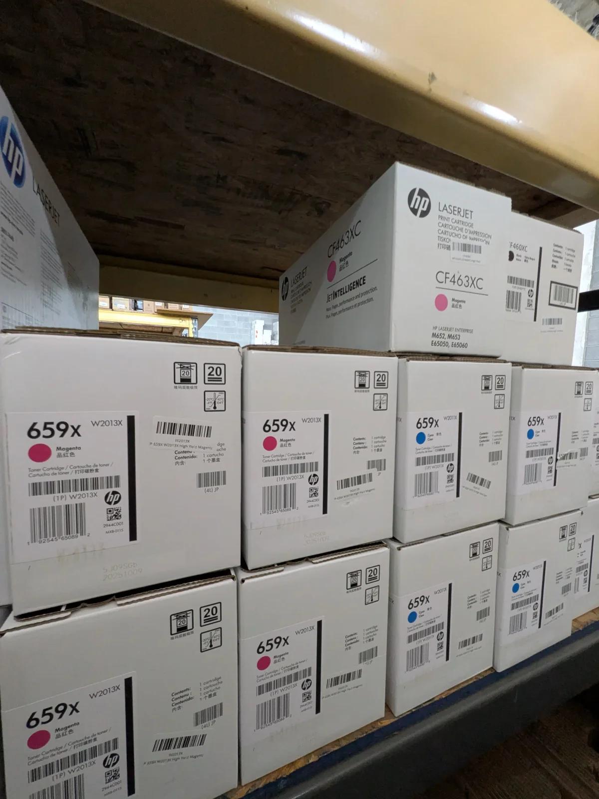 Close-up of sealed toner boxes with clear manufacturer names, model numbers, and intact seals.