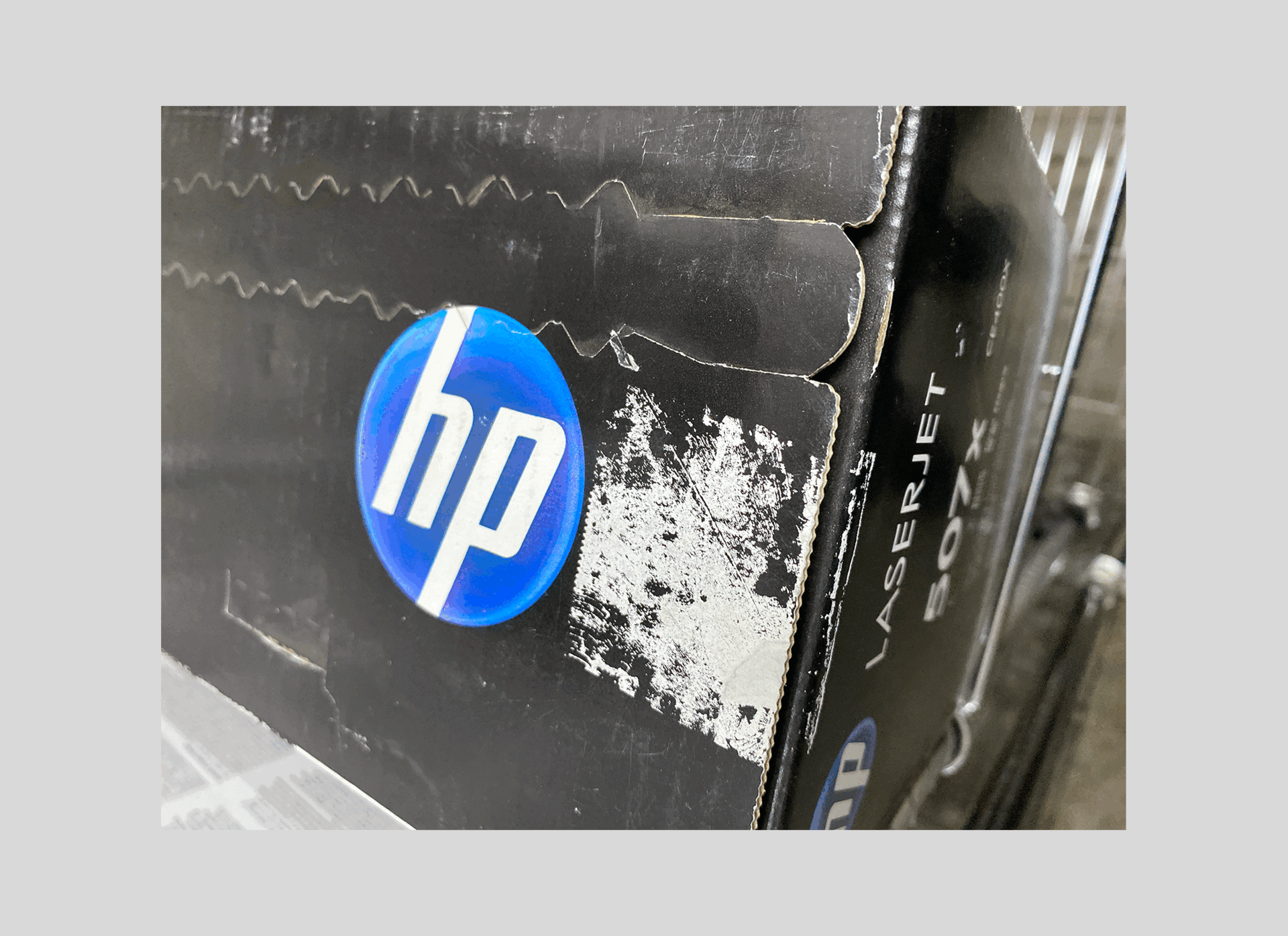 HP toner box with a missing holographic sticker, only glue residue remaining