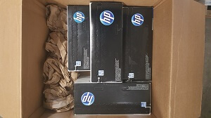 Toner cartridges packed snugly in a box with paper padding for overboxing